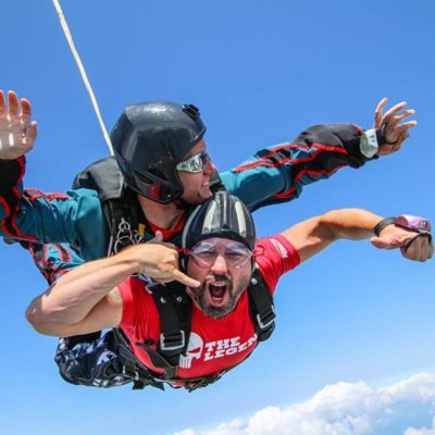Two guys skydiving attached to eachother