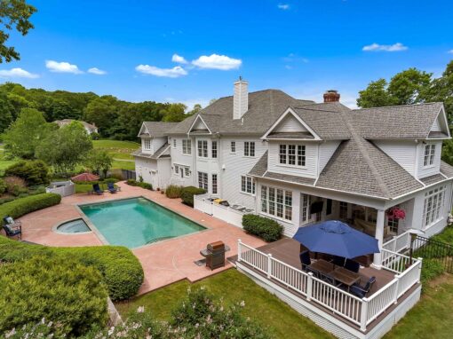 Exterior of back of large home with pool