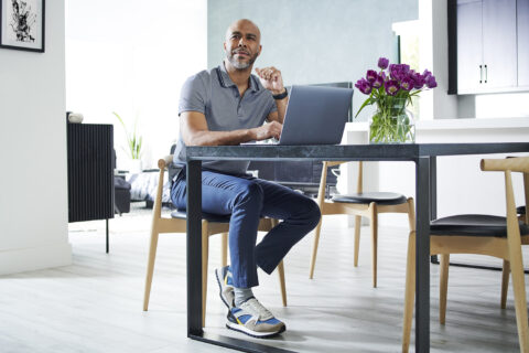 person sitting at a table on the computer