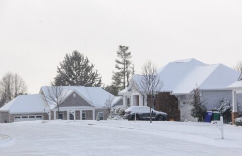 homes in a neighborhood covered in snow