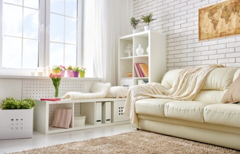 Modern living room with big windows filling room with natural light